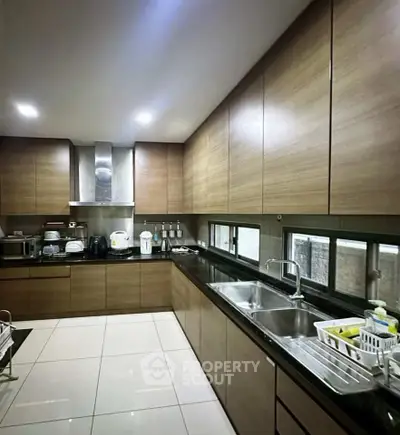 Modern kitchen with sleek wooden cabinets and stainless steel appliances