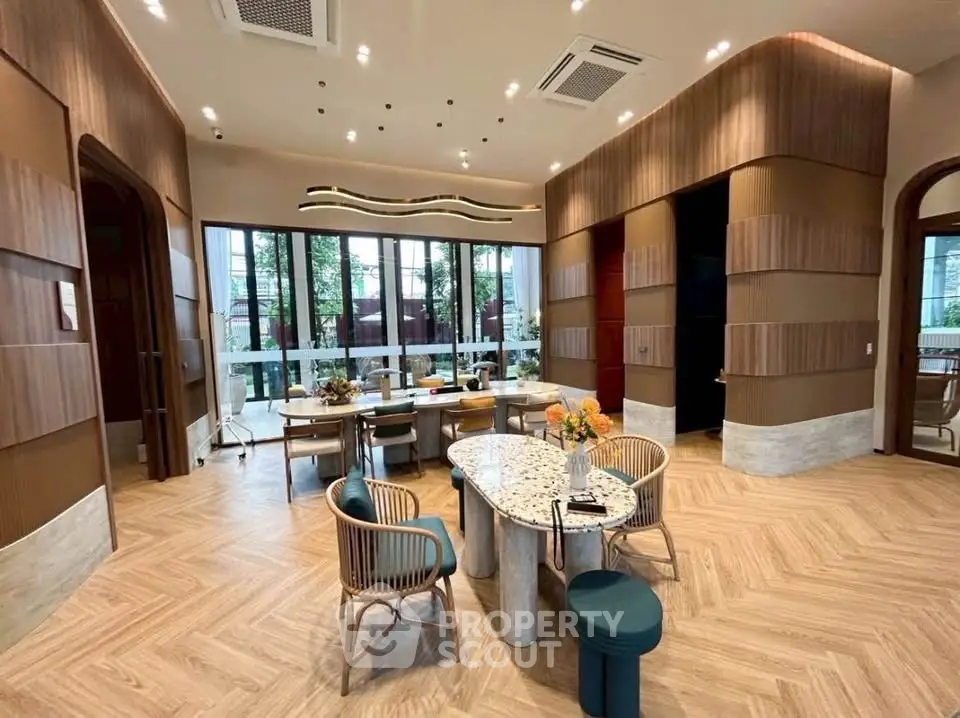 Luxurious modern living room with elegant decor and large windows offering natural light.