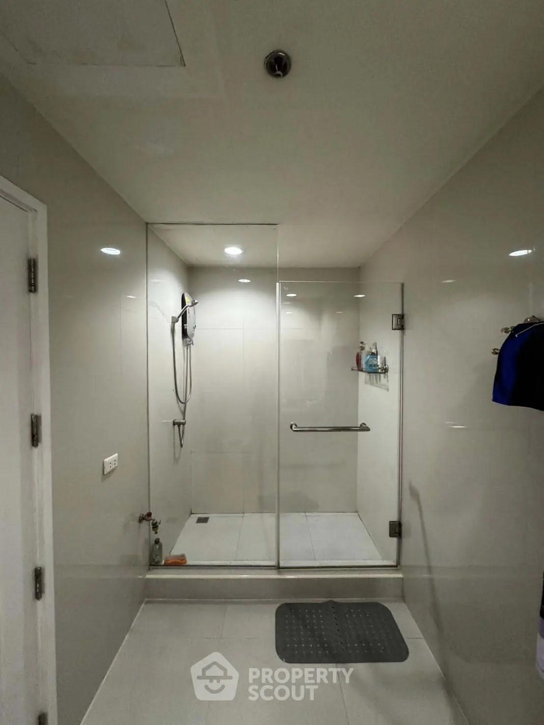 Modern bathroom with glass shower enclosure and sleek design.