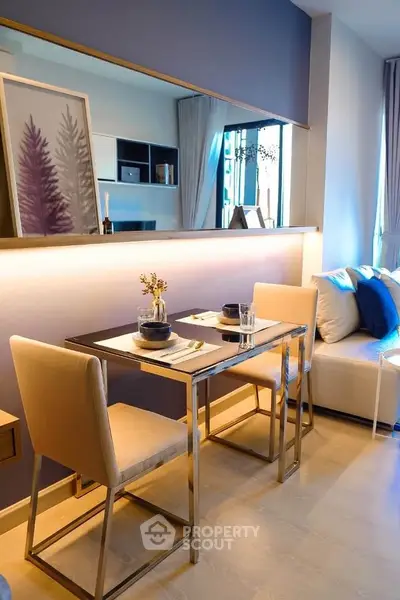 Modern dining area with elegant decor and cozy seating in a stylish apartment.