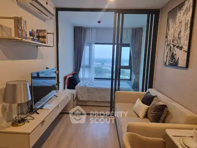 Modern studio apartment with cozy living area and scenic window view