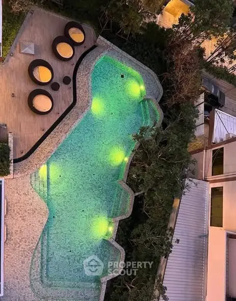 Luxurious rooftop pool with ambient lighting and stylish seating area