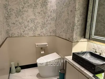 Elegant bathroom with modern fixtures and floral wallpaper