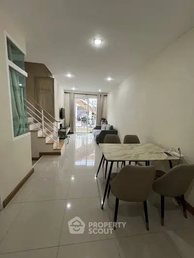 Spacious open-plan living and dining area with modern decor and natural light.