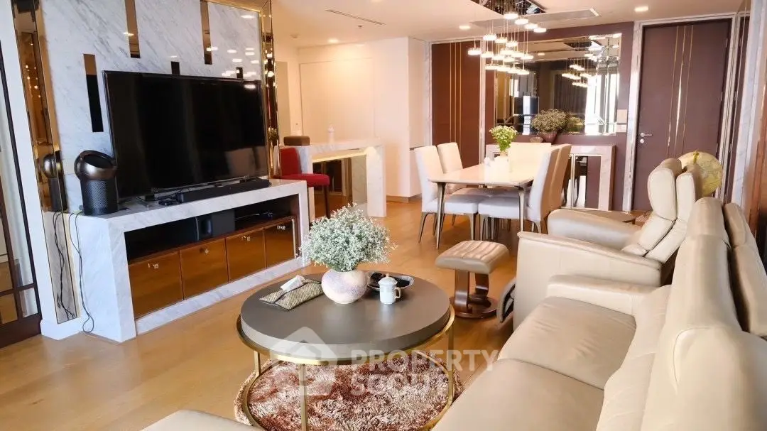 Spacious living room with modern furnishings, large TV, and elegant dining area, perfect for entertaining and relaxation in a luxurious setting.