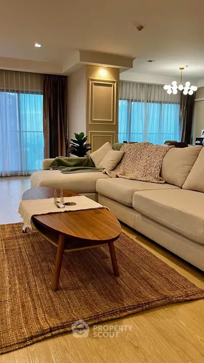 Elegant living room with cozy beige sofa and chic wooden coffee table.