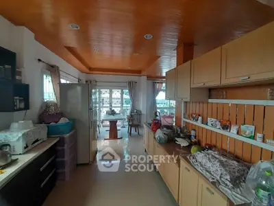 Spacious kitchen with open layout and dining area, featuring modern appliances and ample natural light.