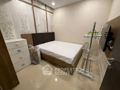 Cozy bedroom with modern decor and ample storage space.