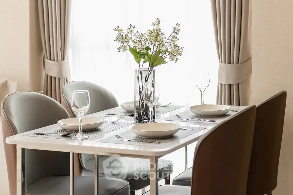 Elegant dining area with modern table setting and stylish chairs in a bright interior.