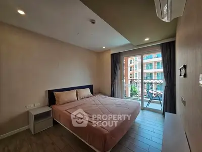 Cozy bedroom with balcony view in modern apartment