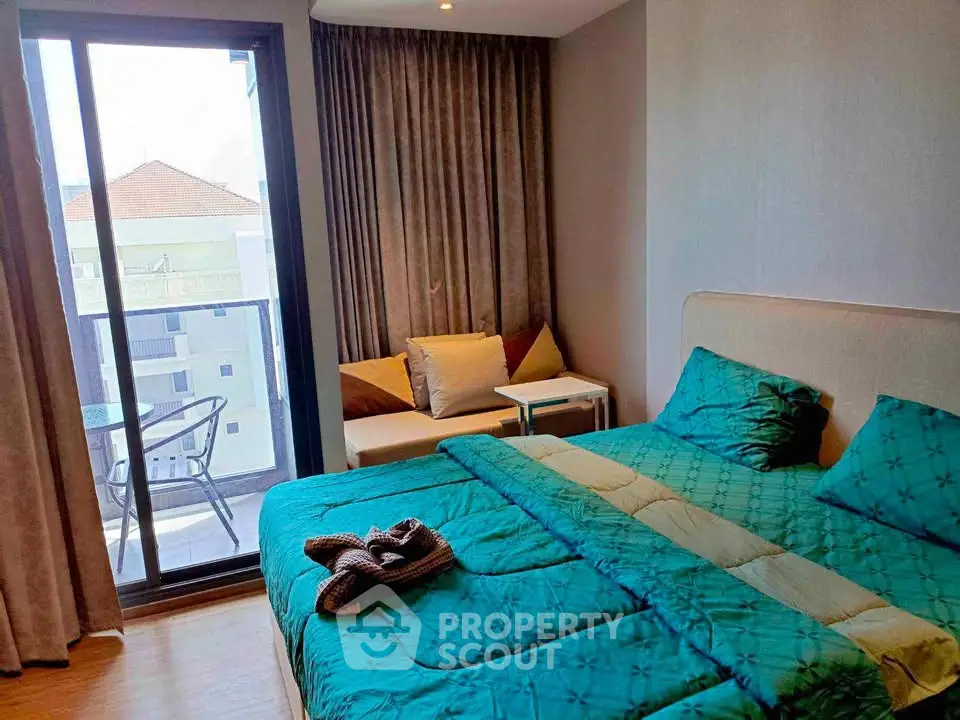 Cozy bedroom with balcony access and stylish decor