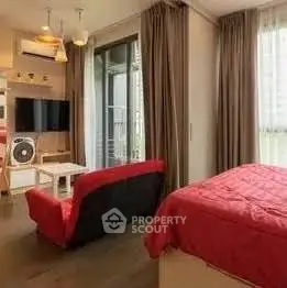 Modern studio apartment with cozy living area and large windows