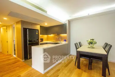 Modern kitchen with sleek design and dining area in open layout apartment