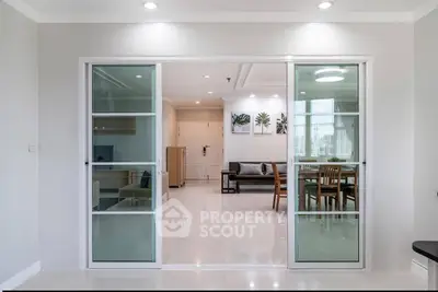 Modern open-plan living room with sliding glass doors and stylish decor