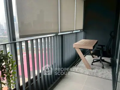 Modern balcony with sleek railing and office setup overlooking cityscape.