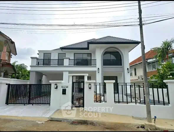 Stunning modern two-story house with sleek design and spacious balcony in a serene neighborhood.
