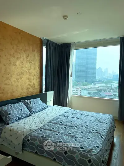 Spacious bedroom with city view and modern decor in high-rise apartment