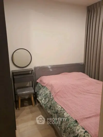 Cozy bedroom with stylish decor and compact design, perfect for urban living.