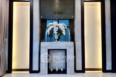 Elegant interior with marble fireplace and floral arrangement in luxury home