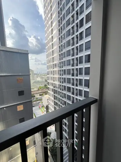 Stunning urban view from a high-rise balcony with cityscape backdrop.