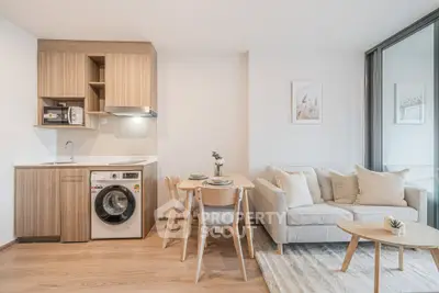 Modern open-plan living room with kitchen, featuring cozy sofa and dining area in stylish apartment.