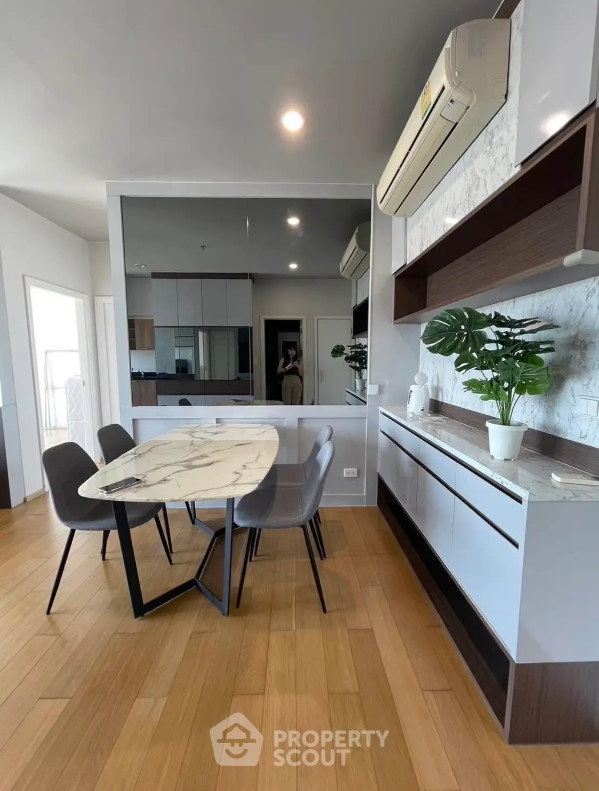 Modern dining area with marble table and stylish decor in a contemporary apartment.
