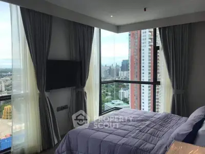 Luxurious corner bedroom with panoramic city views and modern decor.