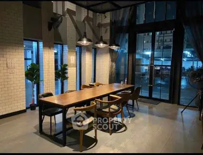 Stylish modern dining area with large windows and elegant lighting in a contemporary apartment.
