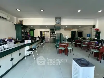 Spacious office interior with modern furnishings and ample natural light, ideal for productive work environment.