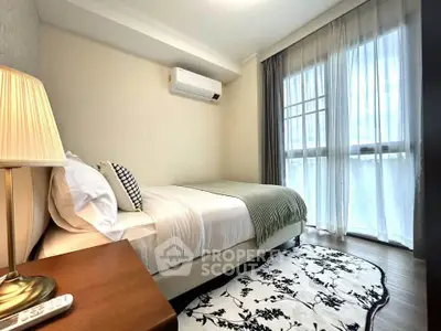 Cozy bedroom with modern decor and large window for natural light