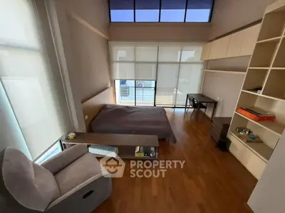 Spacious bedroom with modern design and large windows for natural light