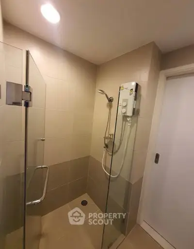 Modern bathroom with glass shower enclosure and sleek fixtures