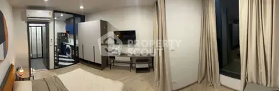 Modern studio apartment with open layout, featuring a cozy bedroom, sleek kitchen, and stylish decor.