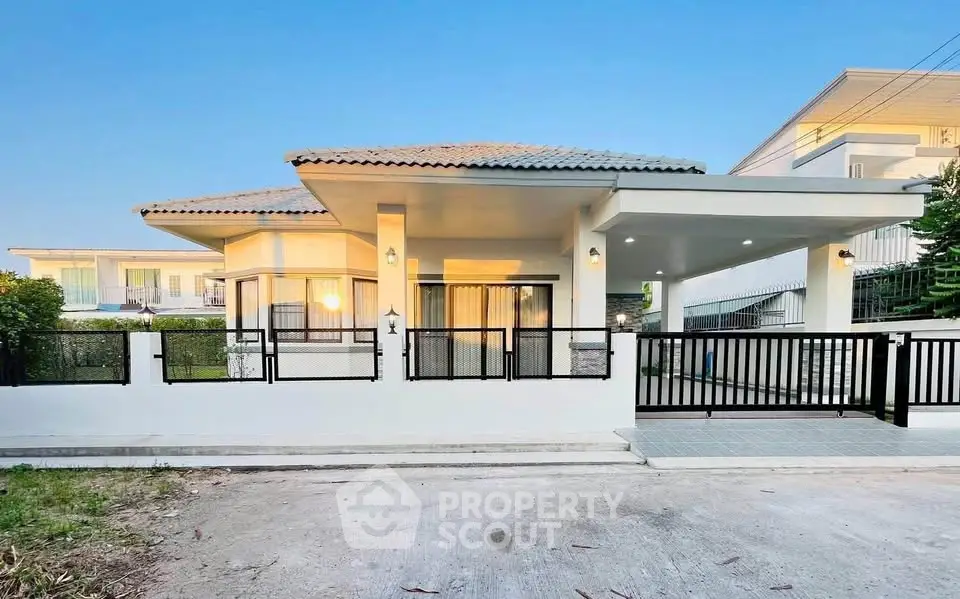Charming single-story house with modern design and spacious driveway in a serene neighborhood.