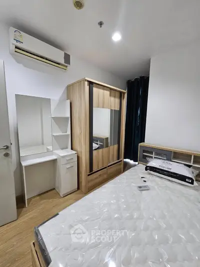 Modern bedroom with wooden furniture and air conditioning in a stylish apartment.