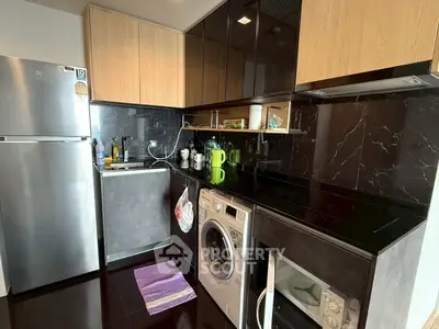 Modern kitchen with sleek black countertops and built-in appliances