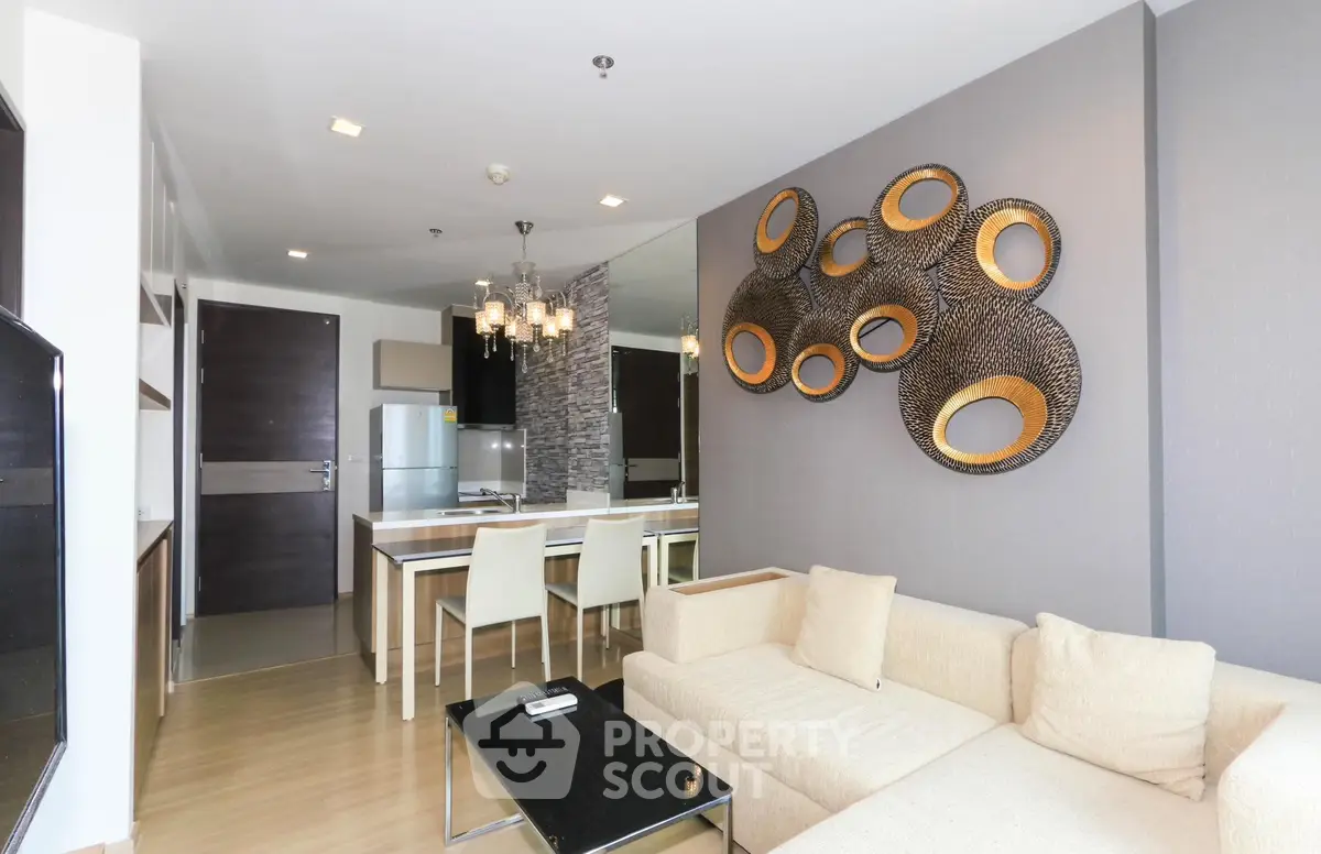 Modern living room with stylish decor and open kitchen layout in a contemporary apartment.