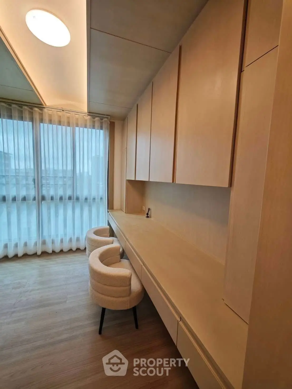 Elegant study room with modern wooden cabinetry and cozy seating