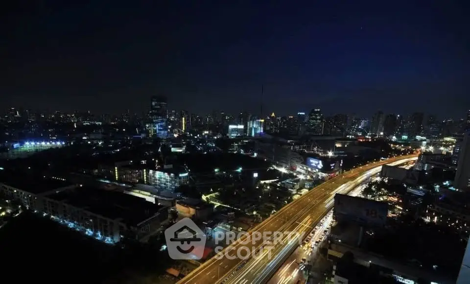 Stunning cityscape view with illuminated skyline and bustling highway at night.