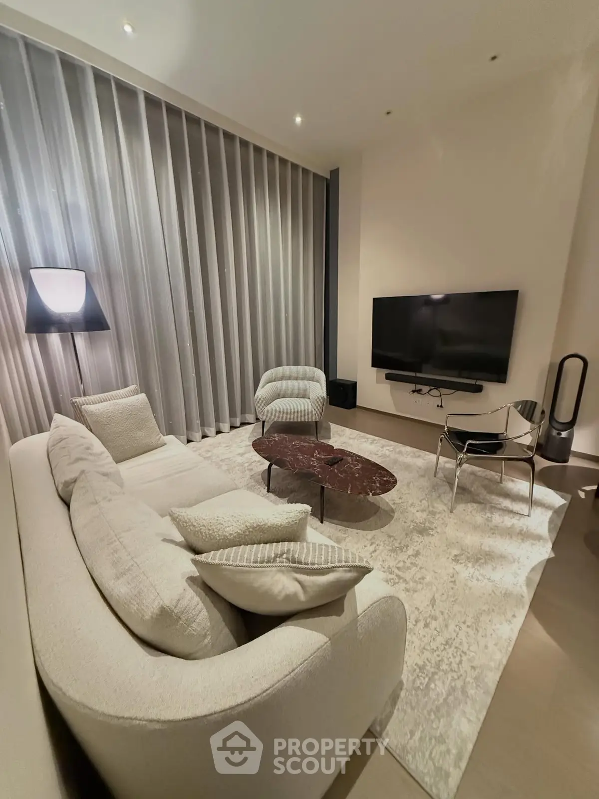 Elegant modern living room with plush sofa and wall-mounted TV