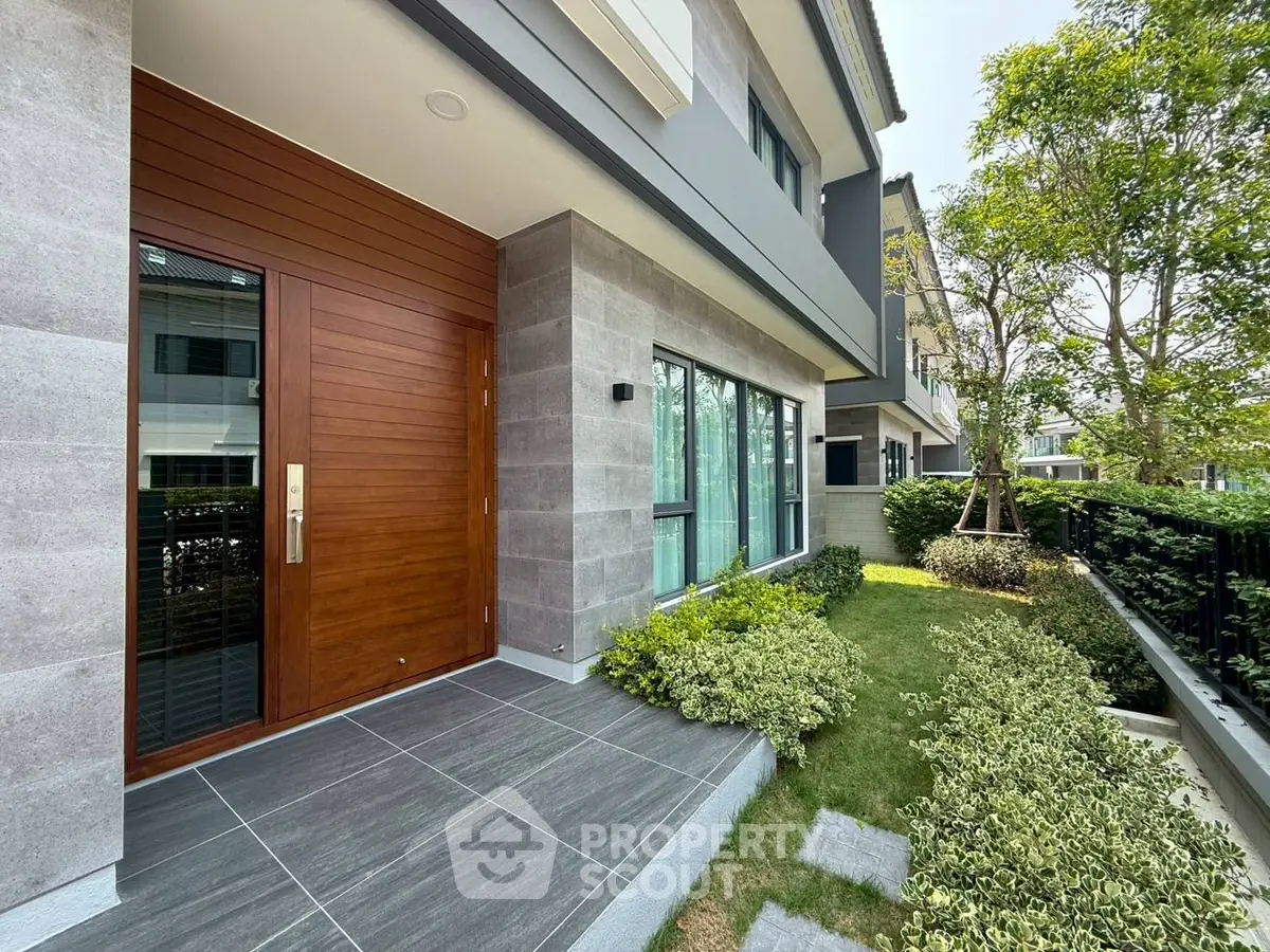 Modern home entrance with lush garden and sleek design