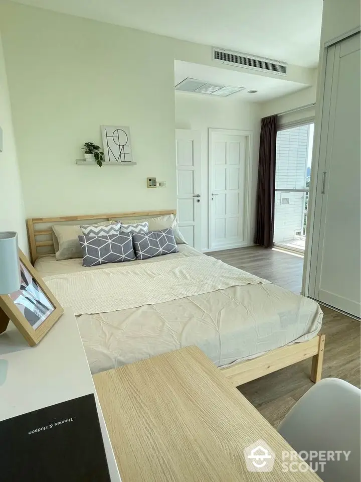 Modern bedroom with natural light and stylish decor in a contemporary apartment.