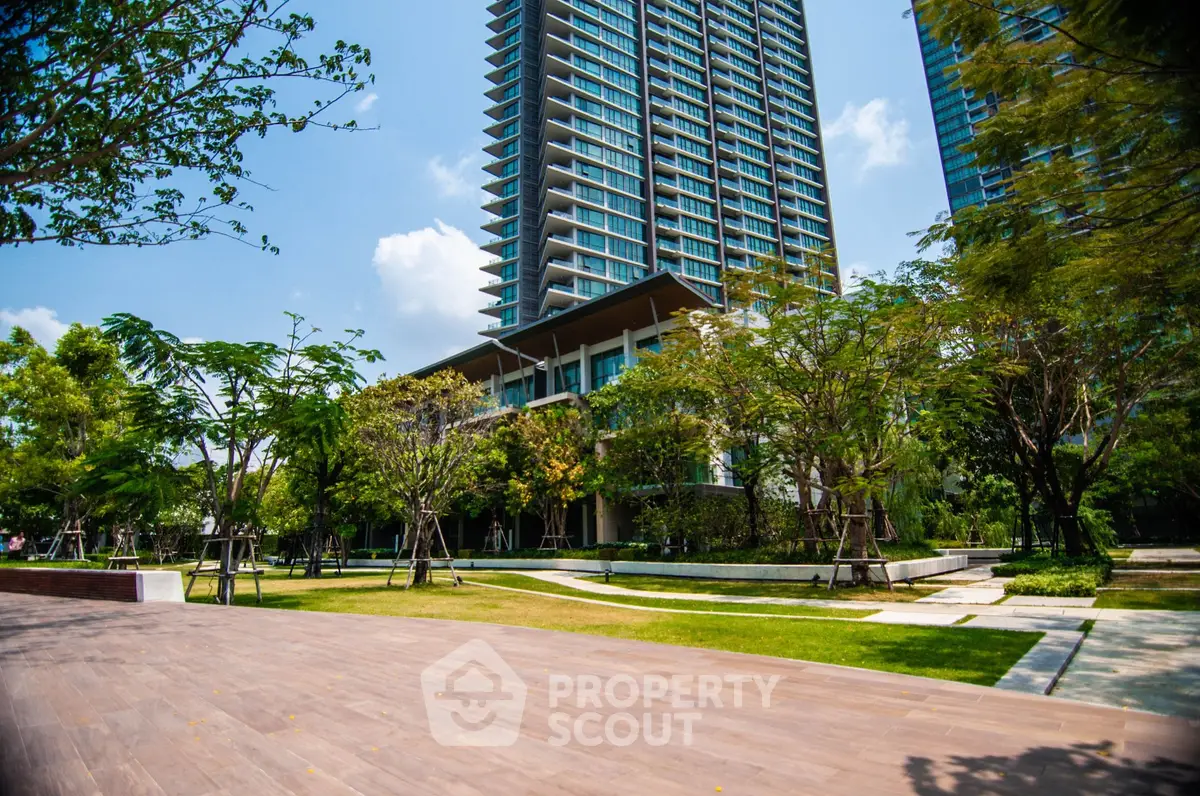 Luxurious high-rise building with lush landscaped garden and modern architecture.