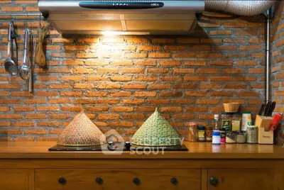 Charming kitchen with exposed brick wall and traditional decor