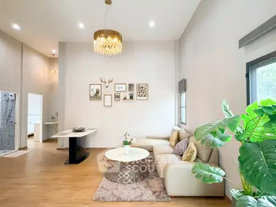 Spacious living room with elegant decor and large windows for natural light.