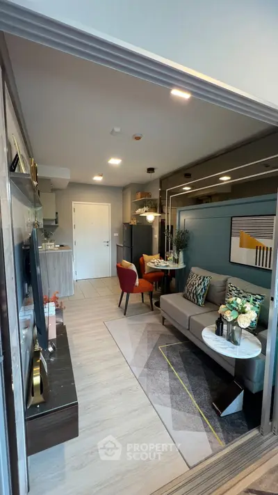 Modern open-plan living room with stylish decor and kitchen view