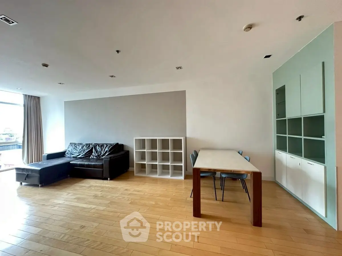 Spacious modern living room with wooden flooring and stylish furniture