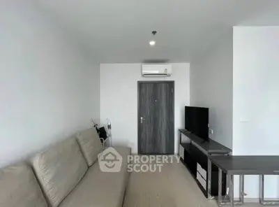 Modern living room with sleek furniture and air conditioning in a contemporary apartment.