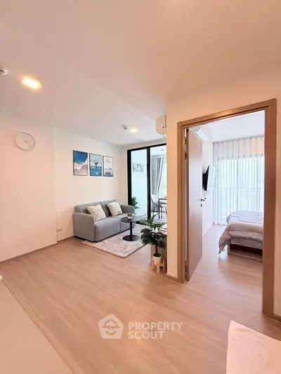 Modern apartment interior with cozy living room and bedroom, featuring stylish decor and natural light.