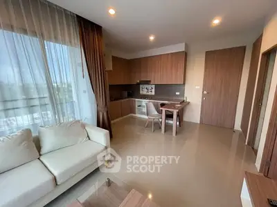 Modern living room with open kitchen and elegant furnishings in a cozy apartment.